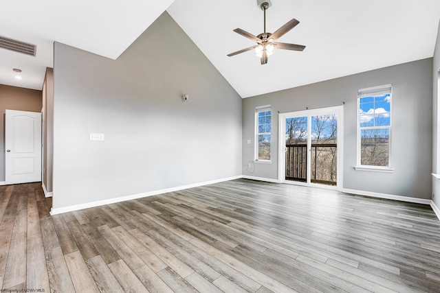 unfurnished living room featuring wood-type flooring, high vaulted ceiling, and ceiling fan