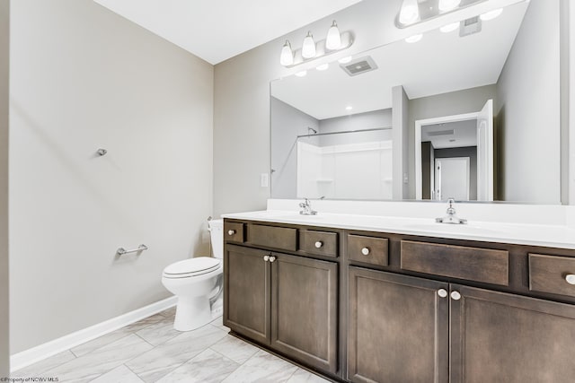 bathroom with walk in shower, vanity, and toilet