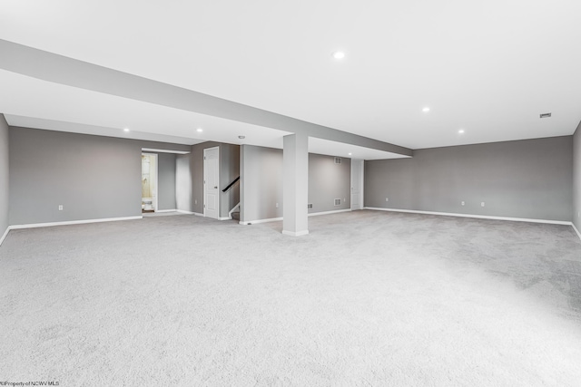 basement featuring light colored carpet