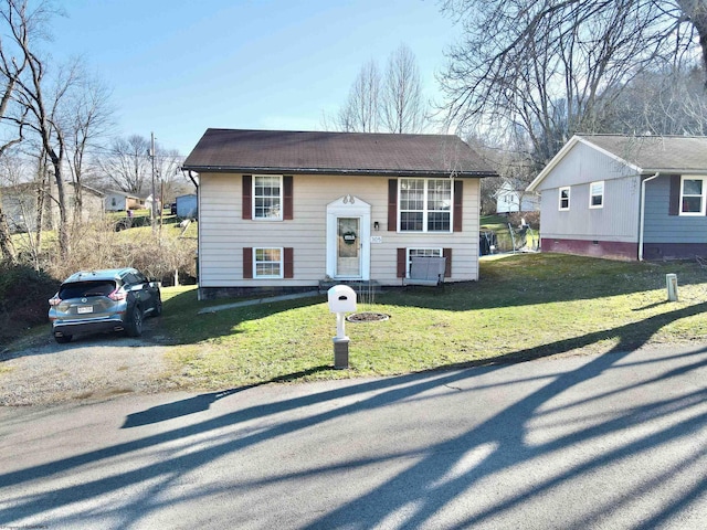 split foyer home with a front lawn