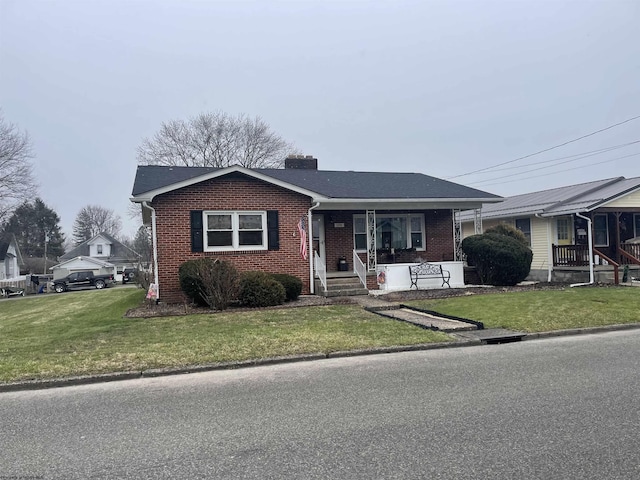 view of front of house with covered porch and a front lawn