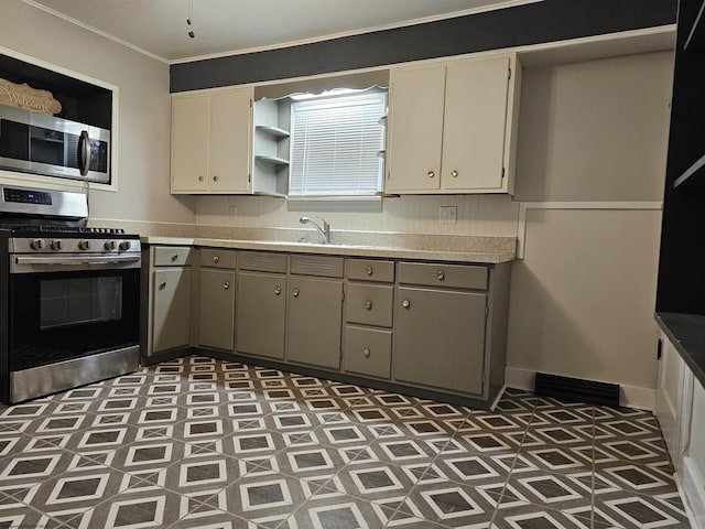 kitchen featuring crown molding, appliances with stainless steel finishes, and sink