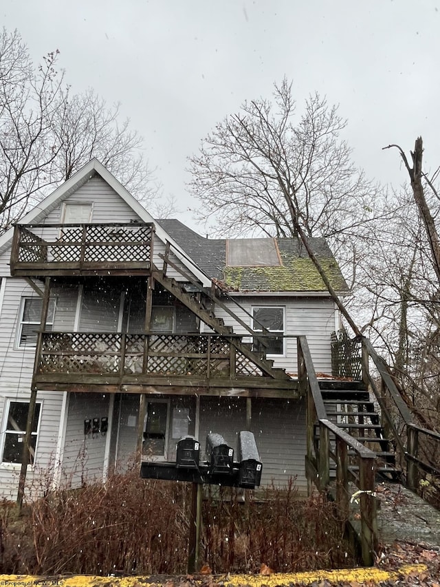 back of property featuring a wooden deck