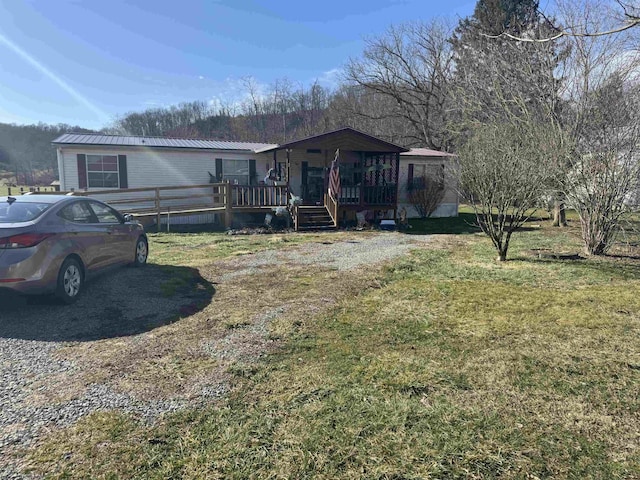 view of front facade with a front lawn and a porch