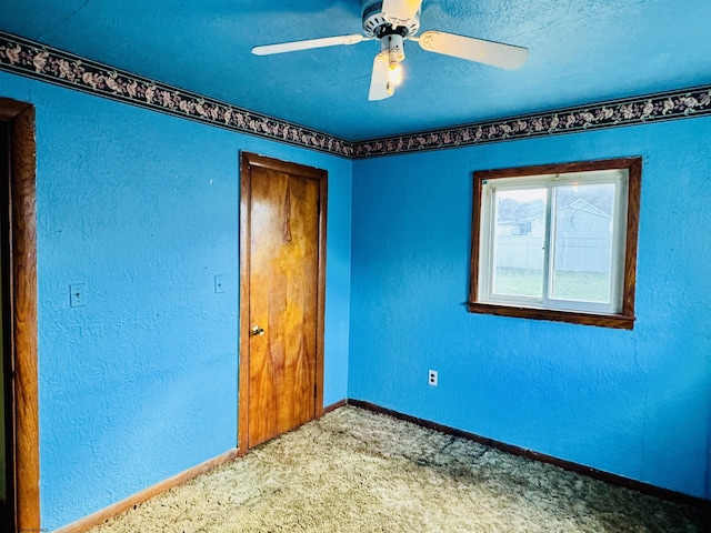 unfurnished bedroom with ceiling fan and carpet flooring