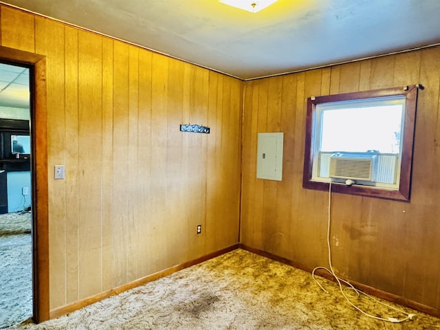 unfurnished room featuring carpet, cooling unit, electric panel, and wood walls