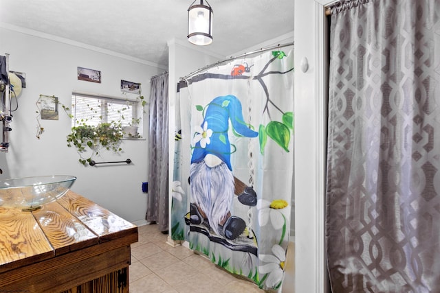 bathroom with tile patterned floors, a textured ceiling, ornamental molding, vanity, and a shower with shower curtain