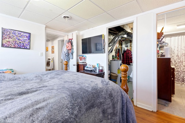 bedroom featuring a paneled ceiling and wood-type flooring