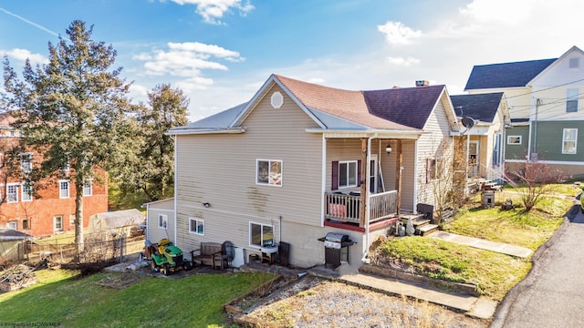 exterior space with a lawn and a porch