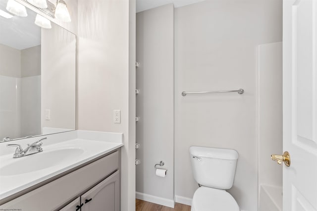 full bathroom featuring bathtub / shower combination, vanity, toilet, and hardwood / wood-style floors