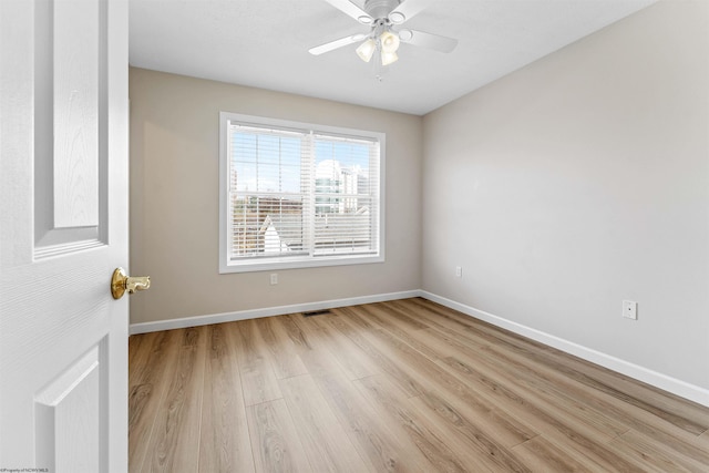 spare room with ceiling fan and light wood-type flooring