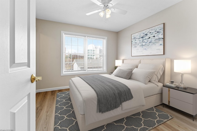 bedroom with ceiling fan and light wood-type flooring