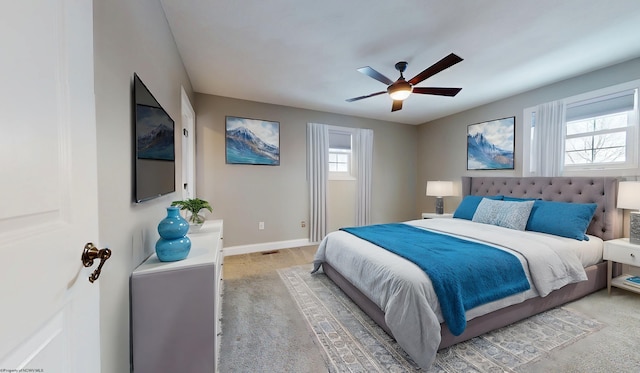 bedroom with light carpet and ceiling fan