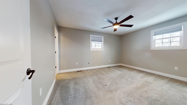 empty room with light colored carpet and ceiling fan