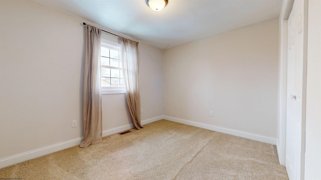 empty room featuring light colored carpet