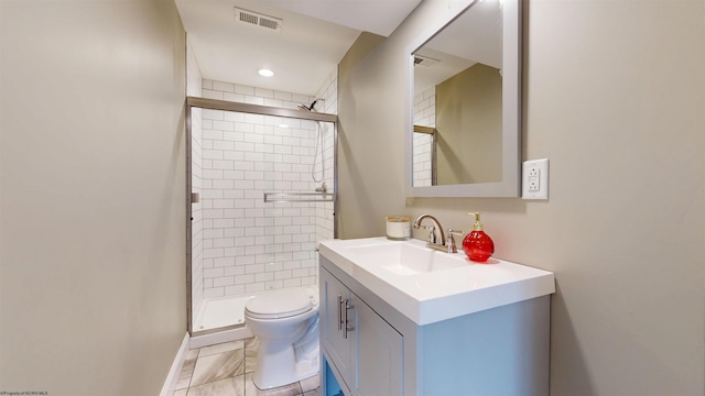 bathroom featuring vanity, toilet, and a shower with door