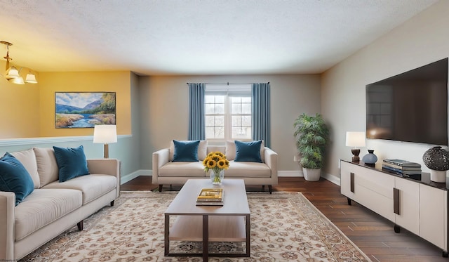 living room with an inviting chandelier, dark wood-type flooring, and a textured ceiling