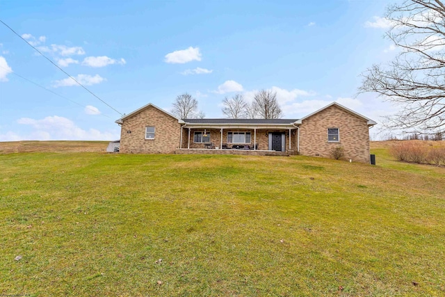 ranch-style house with a front yard and a porch