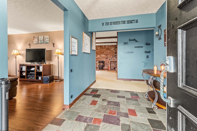 entryway with hardwood / wood-style flooring and a textured ceiling