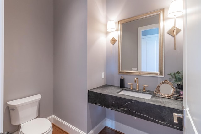 bathroom featuring toilet and sink