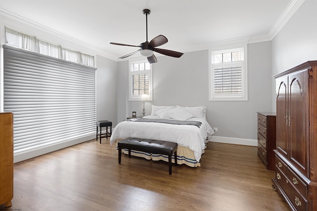 bedroom with hardwood / wood-style flooring, crown molding, and ceiling fan