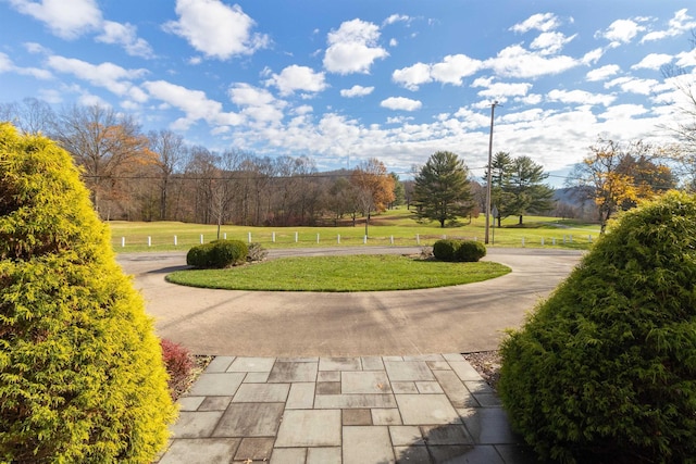 view of property's community with a lawn