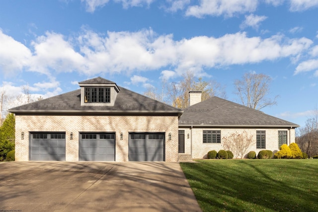 view of front of property featuring a garage and a front yard