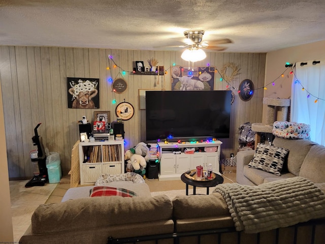 living room with ceiling fan and a textured ceiling