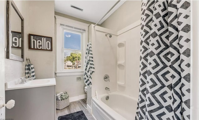 full bathroom featuring vanity, hardwood / wood-style flooring, toilet, and shower / bath combo with shower curtain