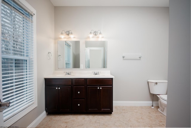 bathroom with vanity, toilet, and tile patterned flooring