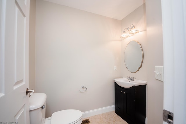 bathroom featuring vanity and toilet