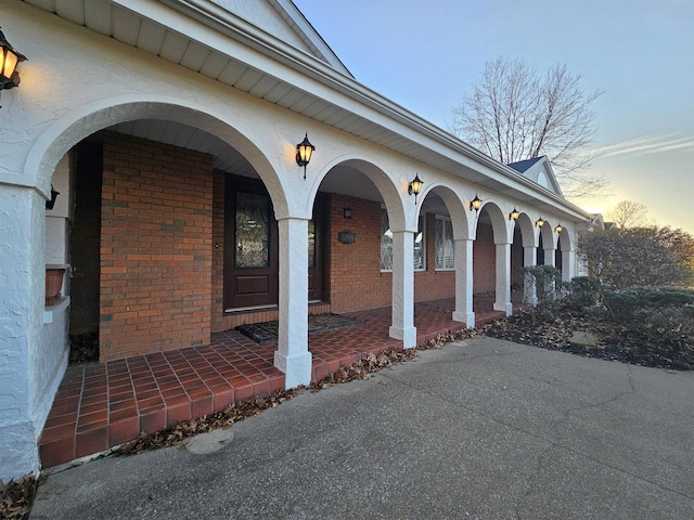 exterior entry at dusk featuring a porch