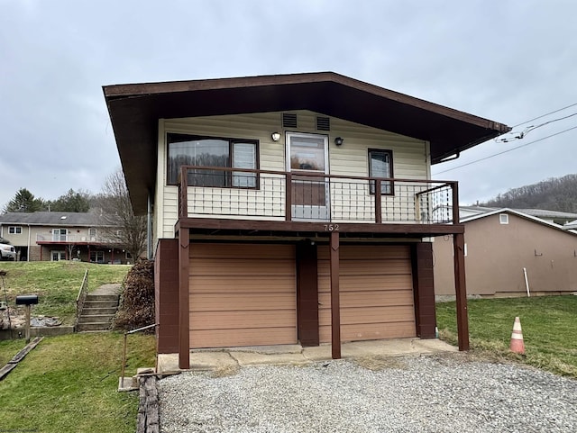 view of front of house with a garage and a front lawn