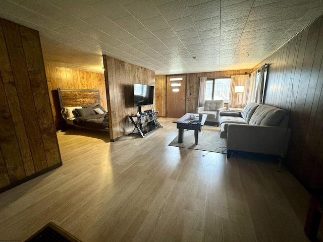 living room with wood walls and light wood-type flooring