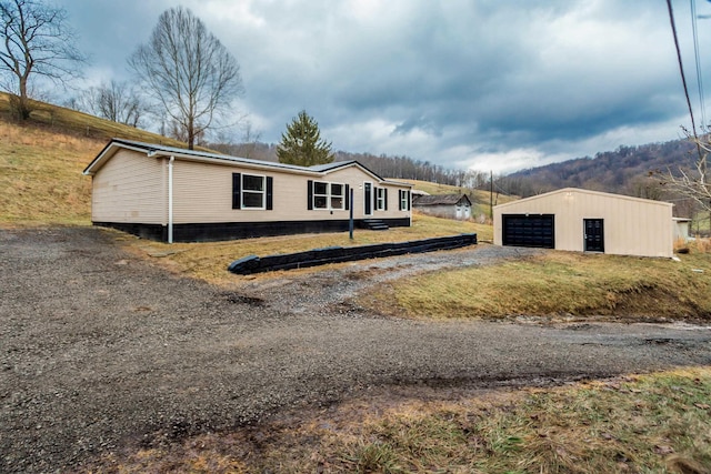 view of front of property with a garage and an outdoor structure