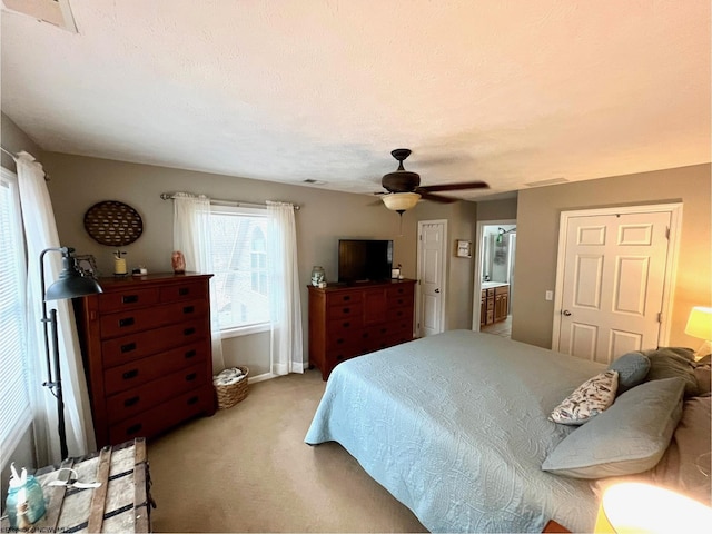 carpeted bedroom with a textured ceiling and ceiling fan