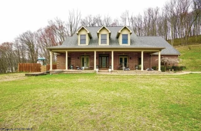 cape cod home with french doors and a front lawn