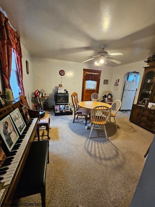 dining area featuring ceiling fan and carpet floors