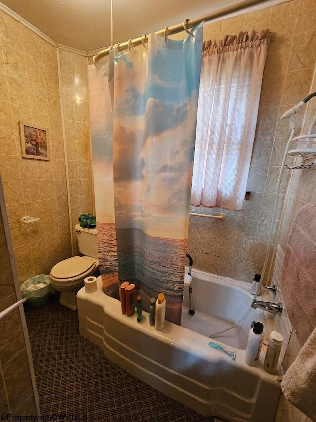 bathroom with tile walls, toilet, shower / bath combination with curtain, and tile patterned floors