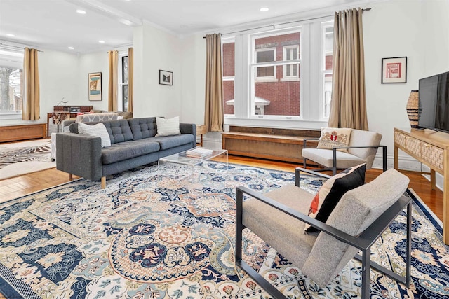 living area featuring wood finished floors, recessed lighting, and ornamental molding