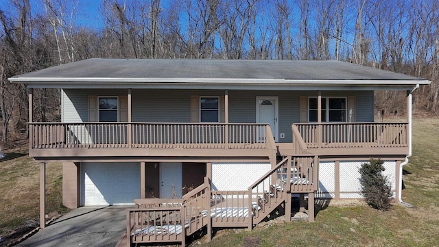 view of front of property with a garage, covered porch, and a front lawn