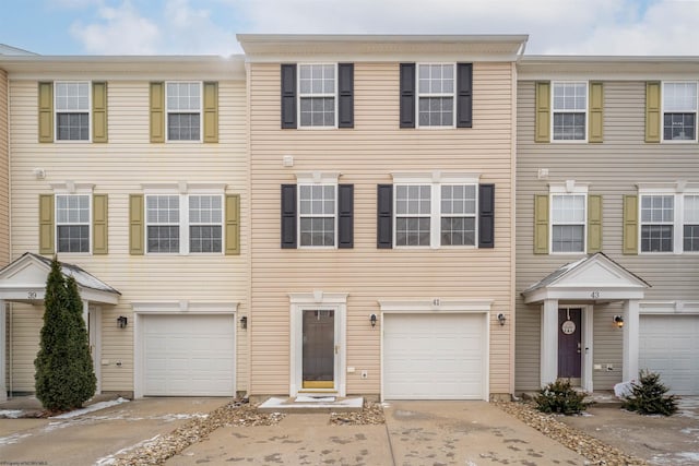 townhome / multi-family property with concrete driveway and an attached garage