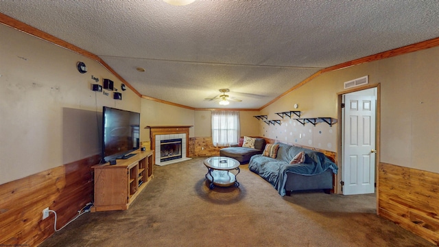 carpeted living room with visible vents, vaulted ceiling, and wainscoting