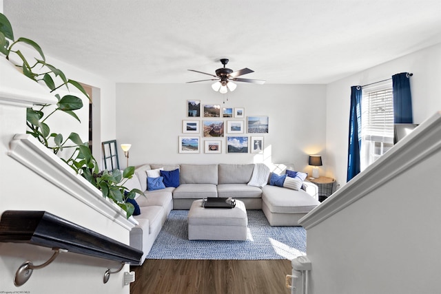 living room with ceiling fan and wood finished floors