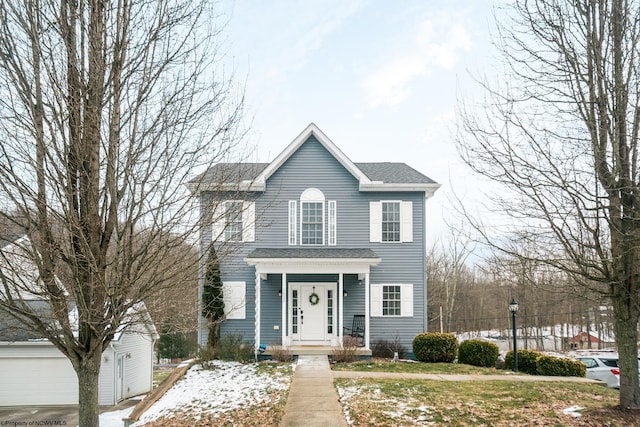 colonial-style house featuring a shingled roof