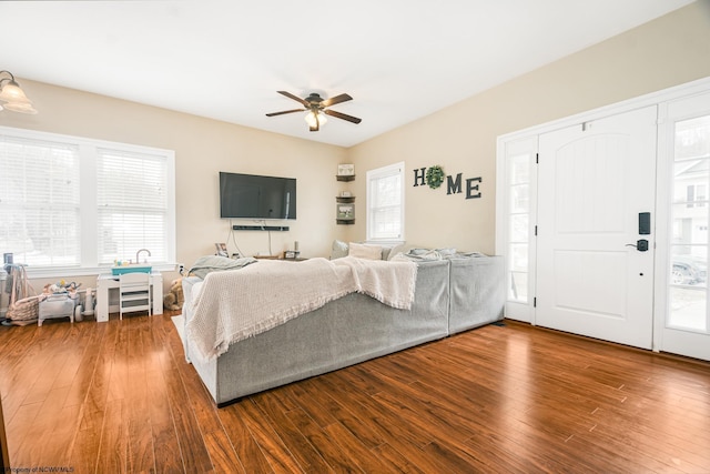 bedroom with a ceiling fan, multiple windows, and wood finished floors