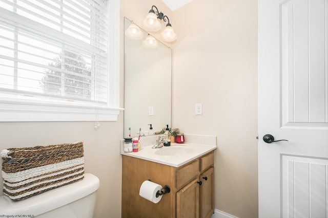 half bathroom with vanity and toilet