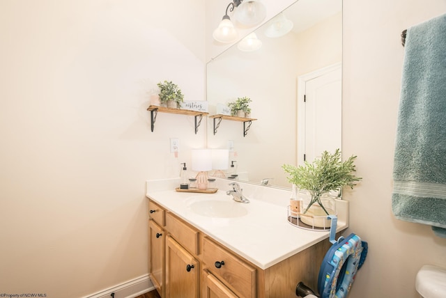 bathroom with vanity and baseboards