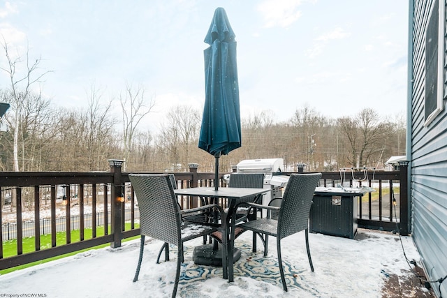 wooden terrace featuring outdoor dining space and fence