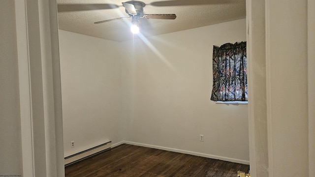 spare room with ceiling fan, a textured ceiling, a baseboard radiator, baseboards, and dark wood finished floors